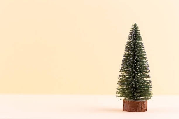 istock Christmas tree on pastel colored background. Christmas or New Year minimal concept. 1384591626