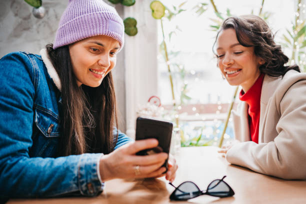 istock Ladies gossiping in cafe 1384602969