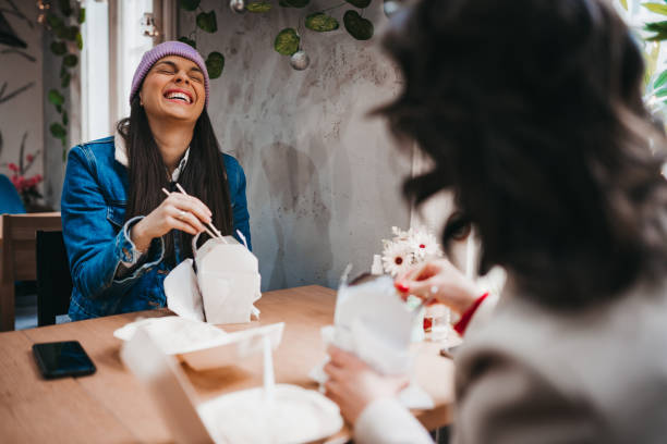 istock Two cheerful women having fun in a Chinese restaurant 1384603754