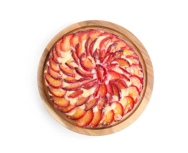 istock Delicious cake with plums isolated on white, top view 1384607933