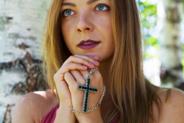 istock Religious young woman praying 1384609472