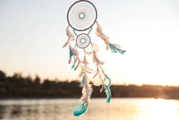 istock Beautiful handmade dream catcher near river on sunny day 1384610372