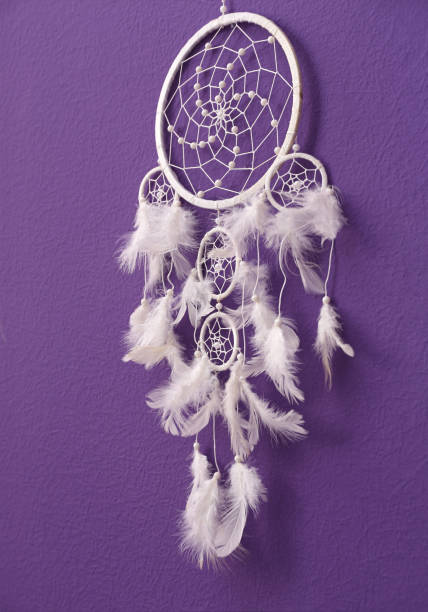 istock Beautiful handmade dream catcher on purple wall 1384610519