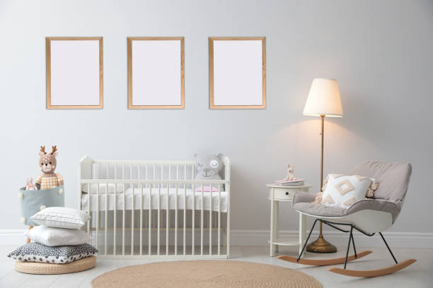 istock Stylish nursery interior with empty posters on wall. Mockup for design 1384611204