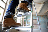 istock Professional constructor on ladder in old building, closeup 1384611950