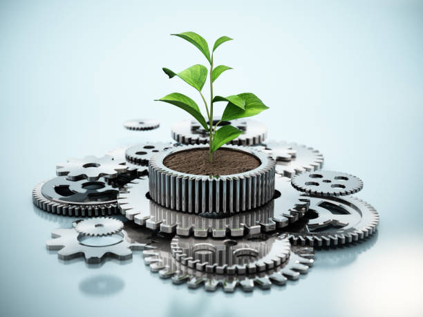 planta que crece dentro de la rueda dentada en forma de maceta en movimiento. concepto de crecimiento industrial sostenible. - plant food agriculture growth fotografías e imágenes de stock