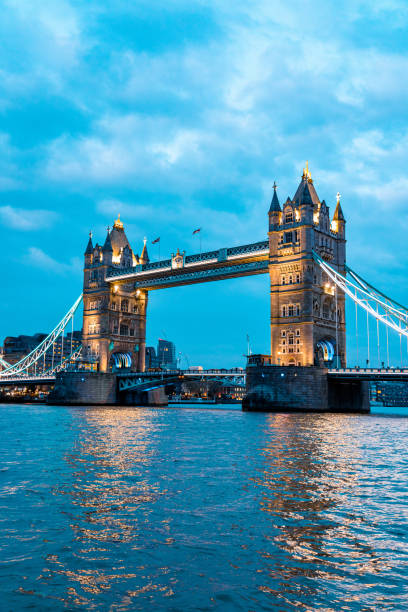 London Tower Bridge illuminated at sunset over River Thames London Tower Bridge illuminated at sunset over River Thames london gherkin at night stock pictures, royalty-free photos & images