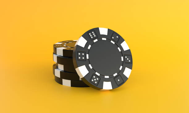 istock Black poker chips on a yellow background with copy space 1384613725