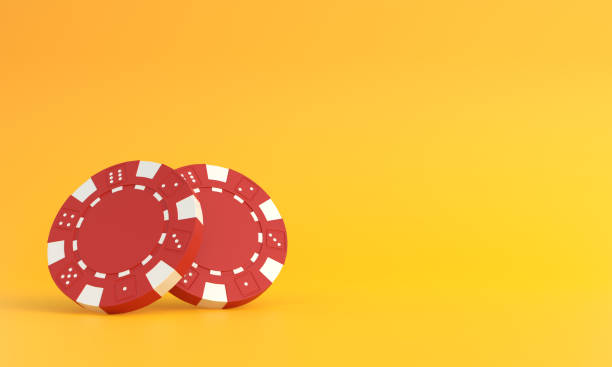 istock Red poker chips on a yellow background with copy space 1384613729
