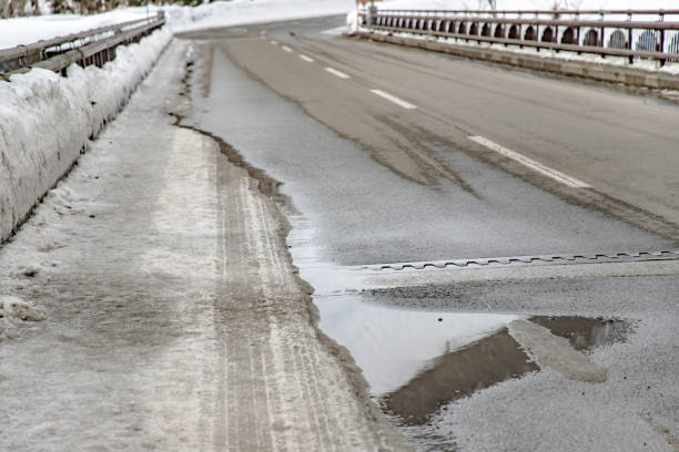 istock Snow that is starting to melt in the road 1384625319