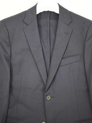 Closeup of a fashionable mens charcoal gray business suit , with white shiort and gray striped tie.