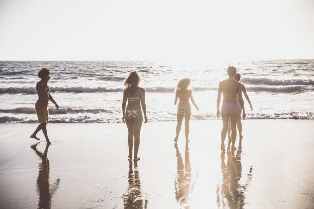 istock Friends running on the beach 1384629043