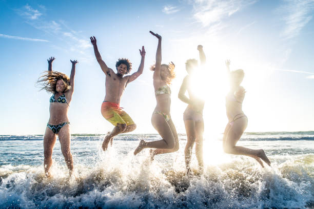 istock Friends running on the beach 1384629217