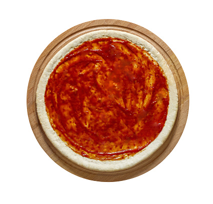 Round dough smeared with tomato sauce - blank for Italian pizza, isolated on white background with clipping path.\
