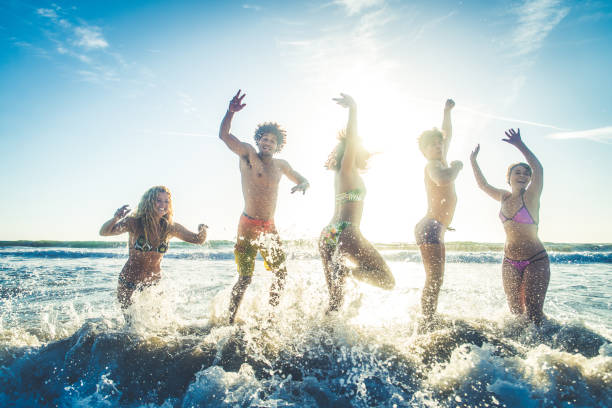 istock Friends running on the beach 1384630048