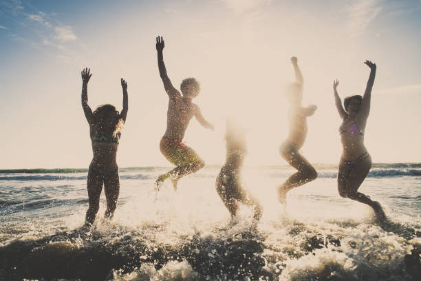 istock Friends running on the beach 1384630301