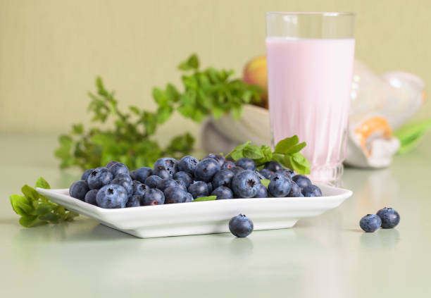 Blueberry yogurt and berries on a kitchen table.