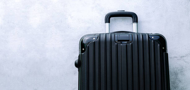 istock Luggage,black suitcase set on a white background top view image flat laying element Minimal travel concept. black and dark classic luggage prototype both small and large luggage accessory set travel concept 1384637363