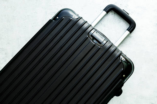 istock Luggage,black suitcase set on a white background top view image flat laying element Minimal travel concept. black and dark classic luggage prototype both small and large luggage accessory set travel concept 1384637378
