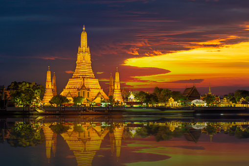 Wat Arun Ratchawararam, Bangkok, Thailand,Wat Arun Ratchawararam Ratchawaramahawihan Public Landmark in Bangkok in sunset time with reflections on water Night shot.