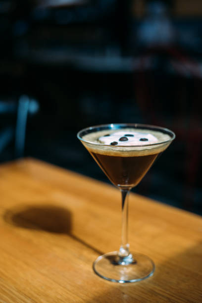 istock Espresso martini coctail garnished with coffee beans on wooden table 1384638960