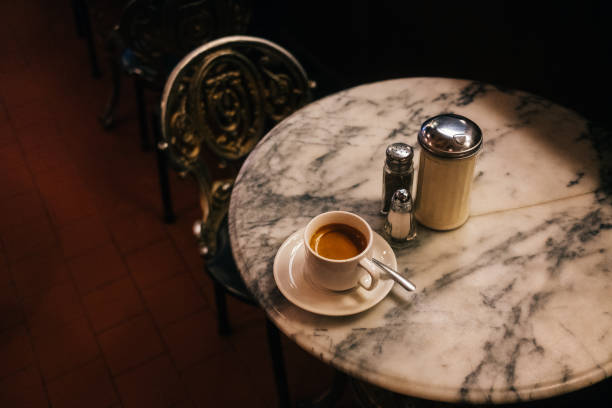 A cup of espresso on a marble table in a Parisin style cafe in Montréal.