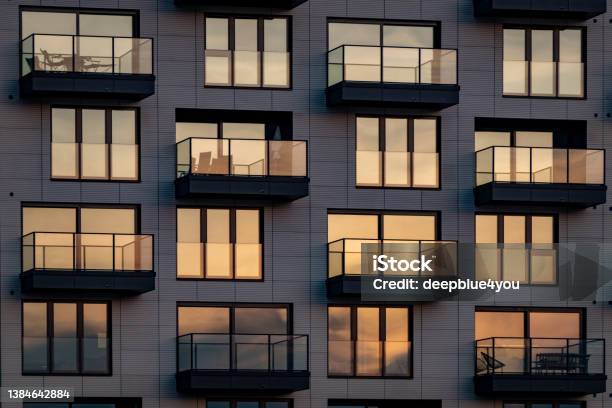 The Evening Sun Is Reflected In The Modern Glass Facade With Balconies Stock Photo - Download Image Now