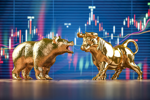 Golden bull and bear on stock data chart background. Investing, stock exchange financial bearish and mullish market concept.