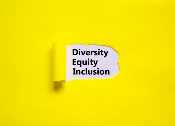 Diversity, equity, inclusion DEI symbol. Words DEI, diversity, equity, inclusion appearing behind torn yellow paper. Pink background. Business, diversity, equity, inclusion concept, copy space. stock photo