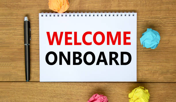 istock Welcome onboard and support symbol. Concept words Welcome onboard on white note. Metallic pen. Beautiful wooden background. Copy space. Business and Welcome onboard concept. 1384648631