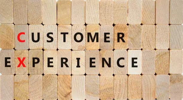 Photo of CX customer experience symbol. Concept words CX customer experience on wooden blocks on a beautiful wooden background, copy space. Business and CX customer experience concept.
