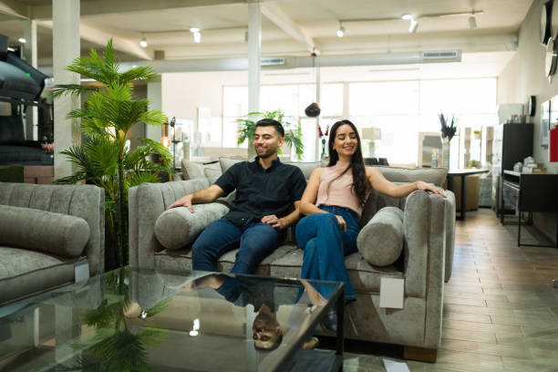 istock Beautiful couple choosing a sofa 1384649756