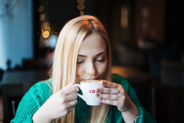 Pretty blonde woman in a cafe.