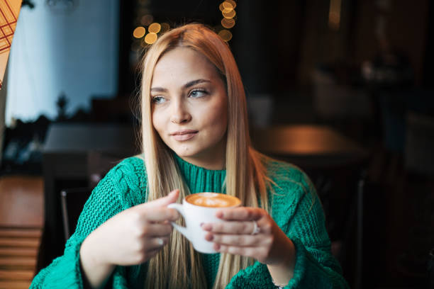 Pretty blonde woman in a cafe.