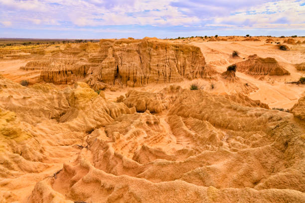 Mungo dry creek sky heap Dry bed of Lake Mungo national park - scenic land mass formation named Walls of China. lakebed stock pictures, royalty-free photos & images