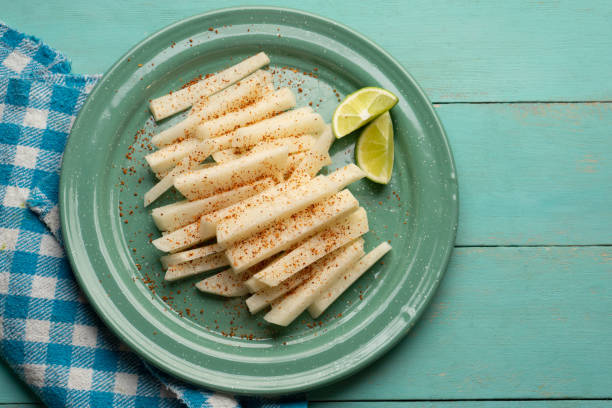 Mexican yam bean also called Jicama with chili powder Cutted mexican yam bean also called Jicama with chili powder pachyrhizus erosus stock pictures, royalty-free photos & images