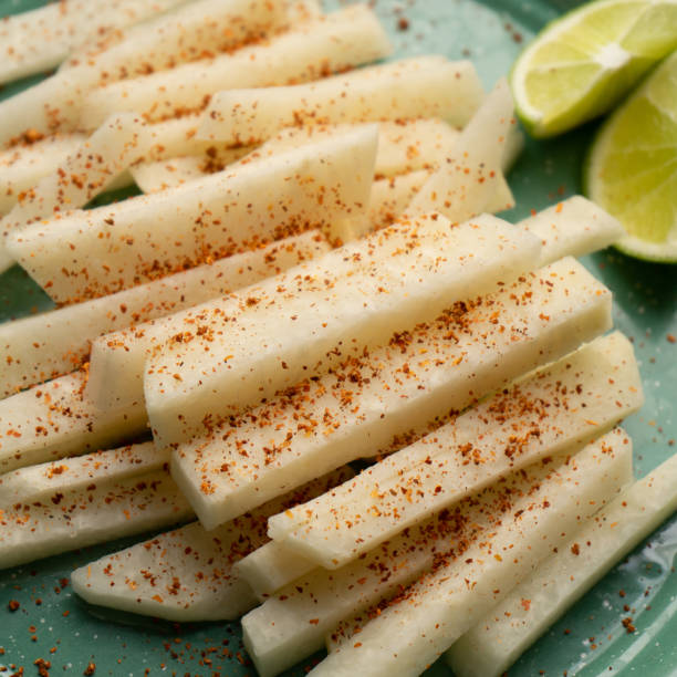 Mexican yam bean also called Jicama with chili powder Cutted mexican yam bean also called Jicama with chili powder pachyrhizus erosus stock pictures, royalty-free photos & images