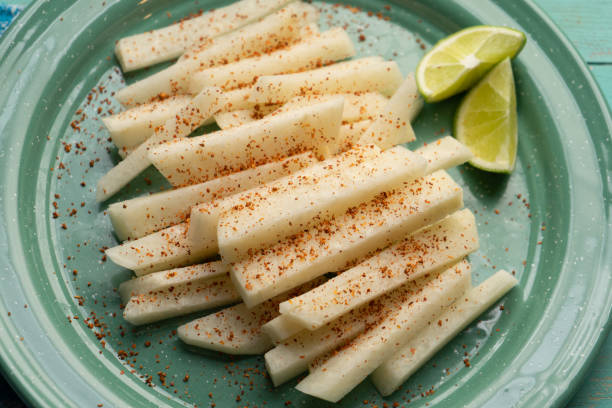 Mexican yam bean also called Jicama with chili powder Cutted mexican yam bean also called Jicama with chili powder pachyrhizus erosus stock pictures, royalty-free photos & images