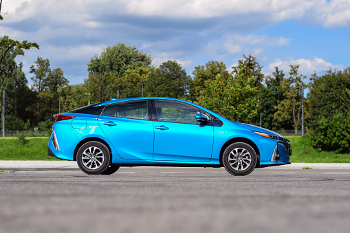 Berlin, Germany – July 15th, 2017: Toyota Prius Plug-in Hybrid on a parking. The fourth generation of Toyota Prius was debut in 2015 but the Plug-in version was debut one year later. The Prius was the first mass-produced hybrid car in the world.