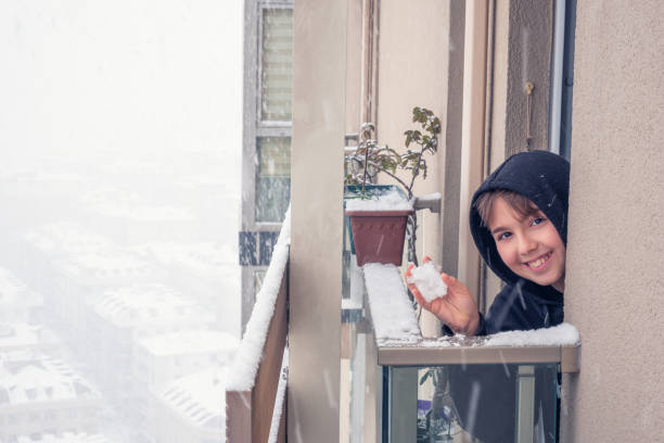 istock The happy boy watches the falling snow 1384664059