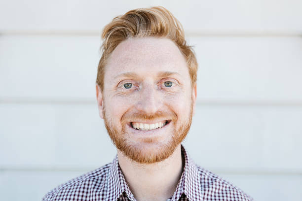 istock Redhead young adult man smiling while standing outdoors 1384665452