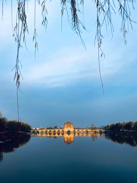istock Ancient Chinese style bridge on tranquil water, Yunnan Province, China 1384666046