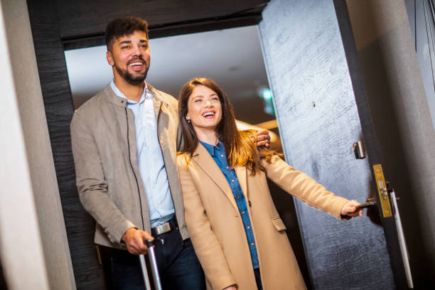 istock Smiling couple entering in the hotel suit 1384669745
