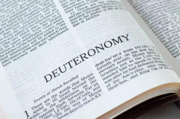 Deuteronomy open Holy Bible Book close-up. Old Testament Scripture. Studying the Word of God Jesus Christ. Christian biblical concept of faith, hope, and trust.
