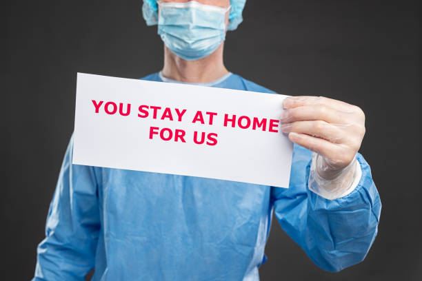 istock Crop doctor in protective uniform with paper banner 1384672817