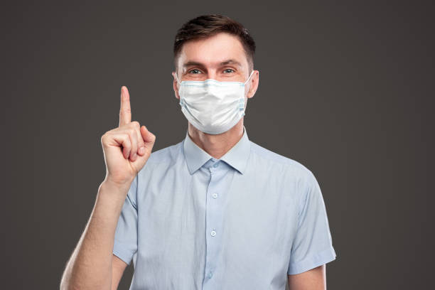 istock Smiling man with index finger up having idea 1384672831