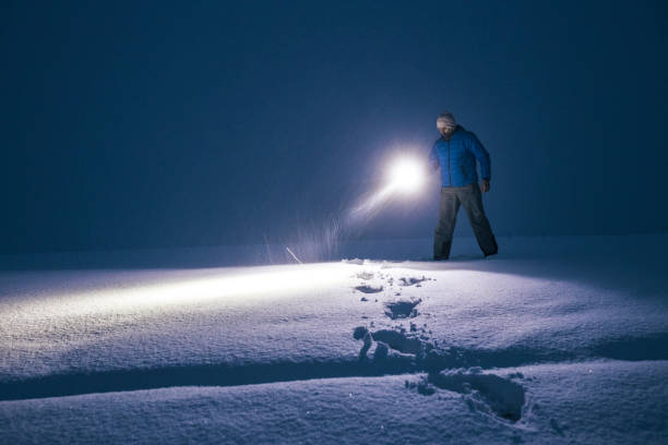 istock Man in deep snow at night searching for the road. 1384673053