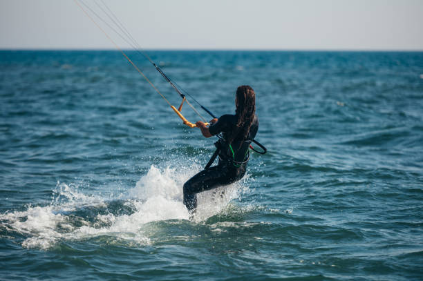 istock Woman kitesurfing on the ocean waters 1384673238