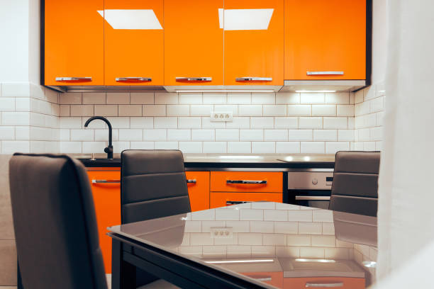 istock Small modern orange kitchen renovated in new apartment 1384677494
