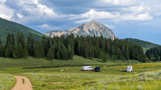 A Summer evening view of a remote campground at base of Mount Crested Butte. Crested Butte, Colorado, USA.